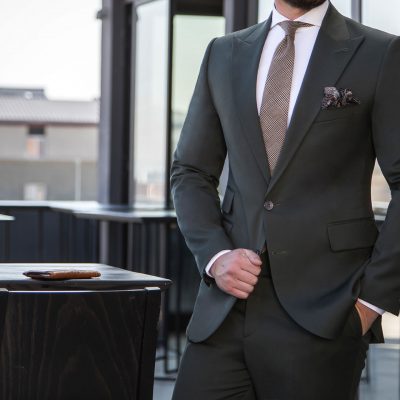 Man in expensive custom tailored suit standing and posing outdoo